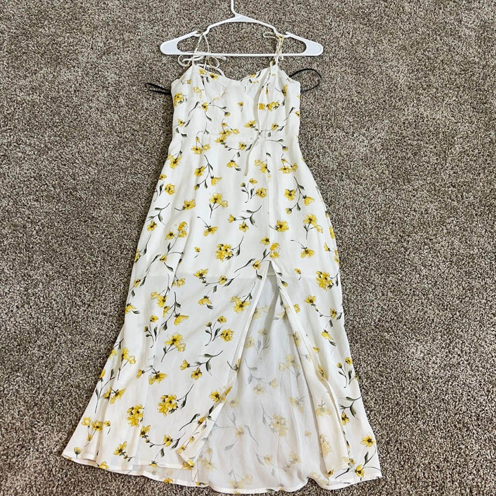 It’s a white dress with yellow flowers on it
